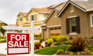 House with for for sale sign in front with blurred background open ai property